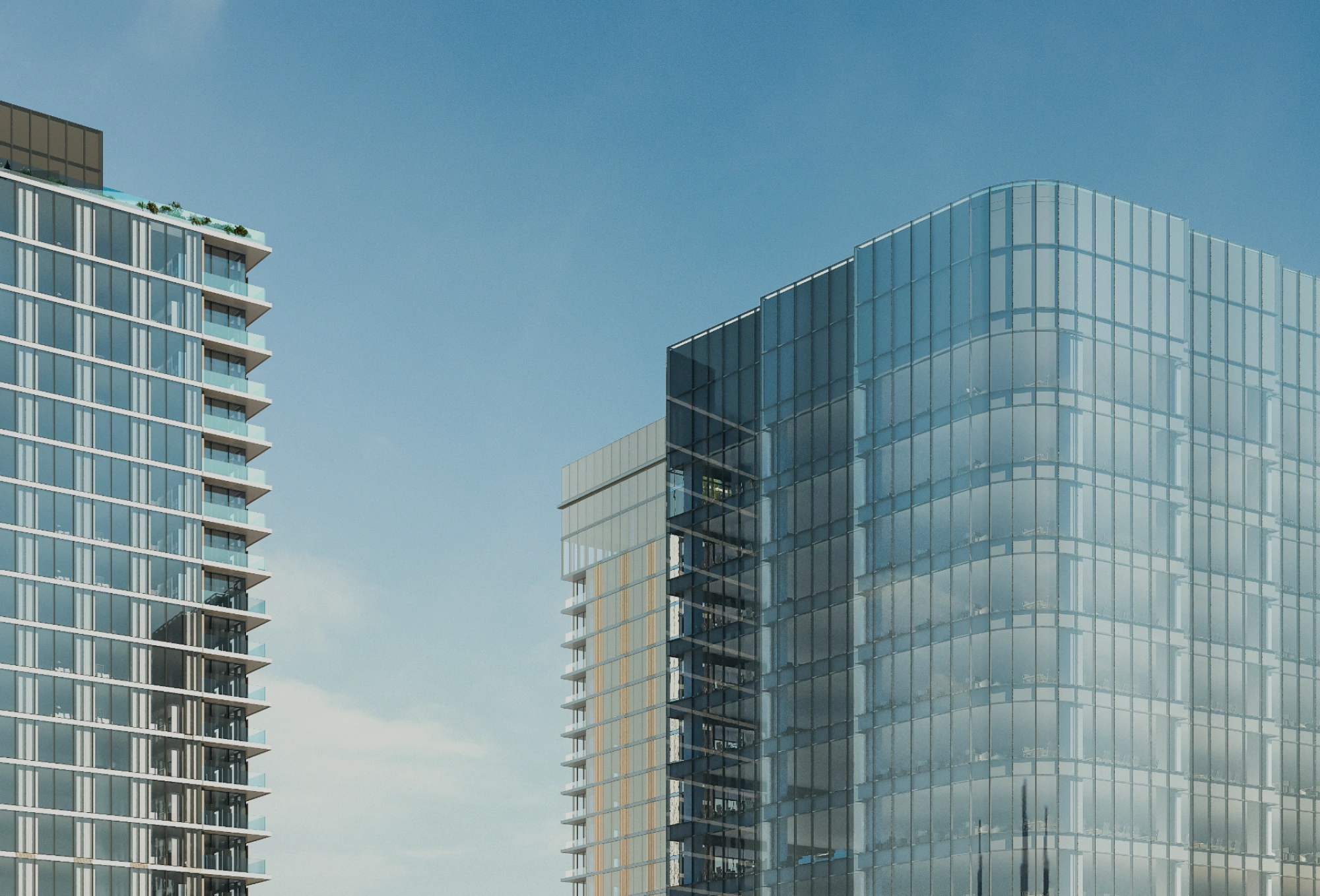 Modern glass office towers with reflective curtain wall facade against blue sky